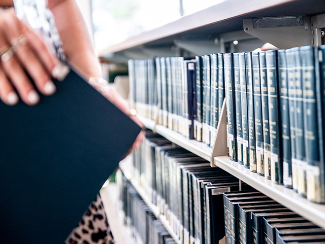 hand taking book from library shelf