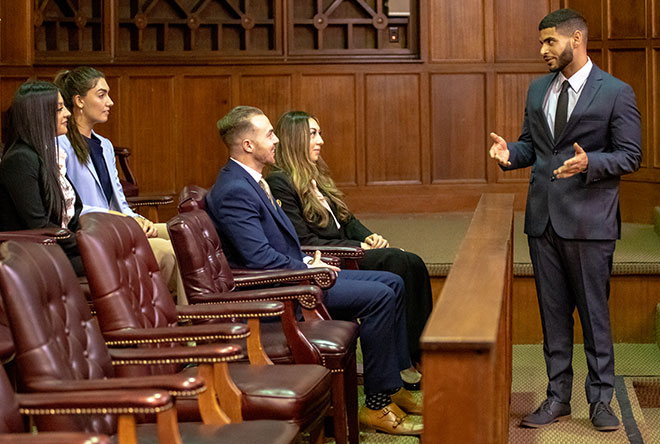 Student talking to the mock jury in the moot courtroom