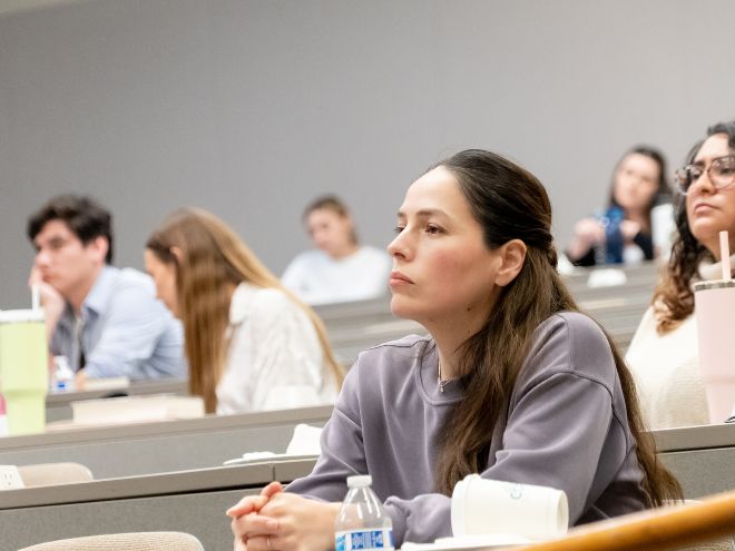 Students listening to a professor during a lecture