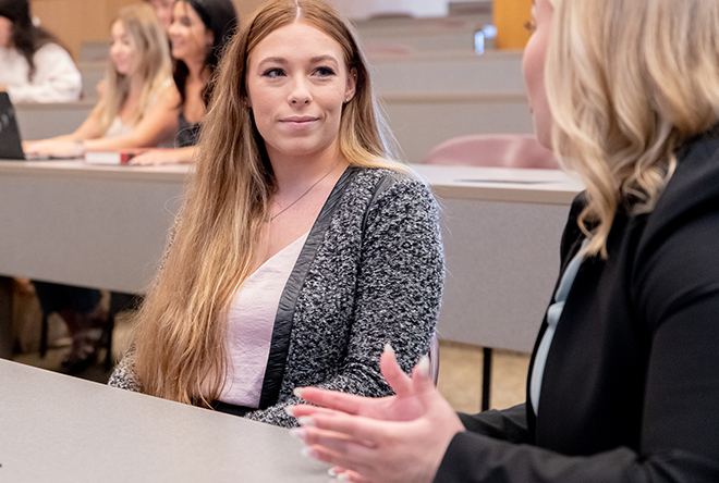 Two students discussion class lecture