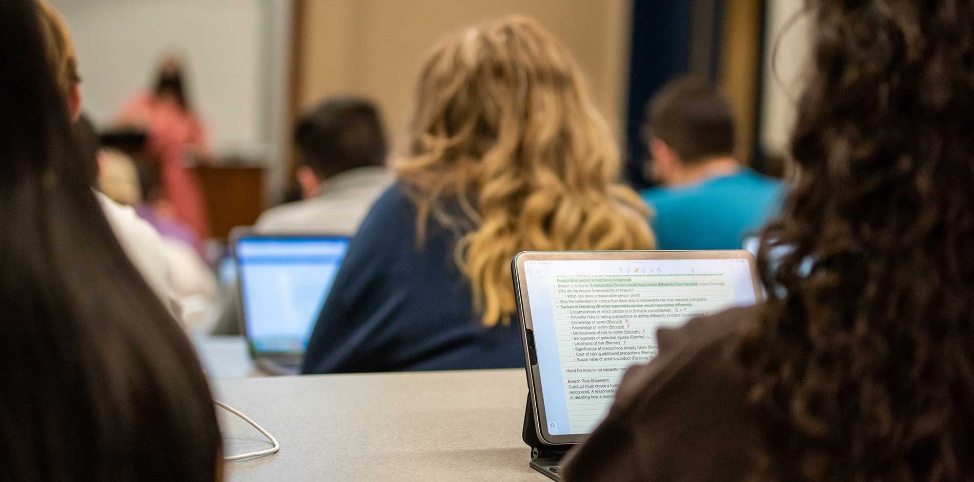 closeup of student on a computer in the classroom