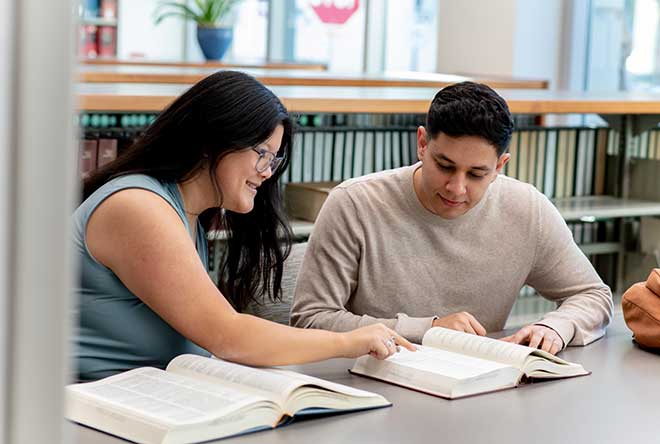 two students studying in the library