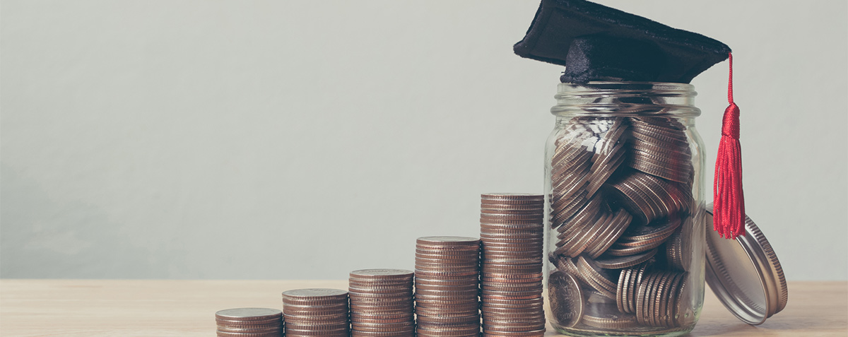 graduation cap on top of jar of coins