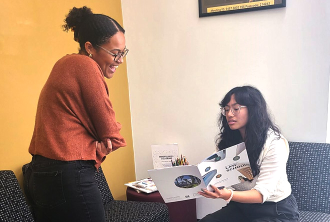 Students at admissions office with a staff member