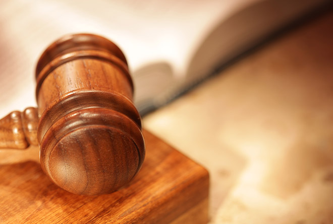 Wooden gavel with book behind it