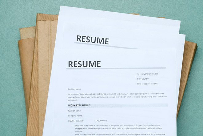 two resumes on top of a folder