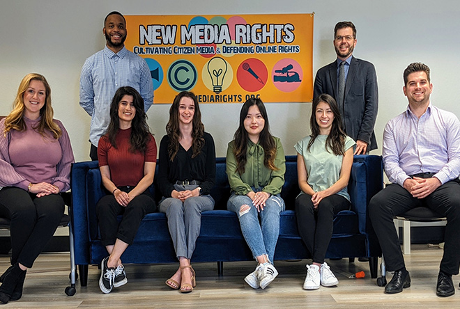 photos of new media rights interns in front of sign