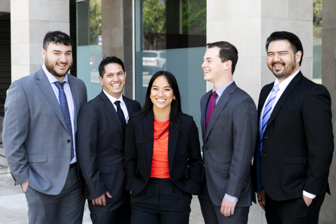 The ADR team poses in front of a building for a group photo
