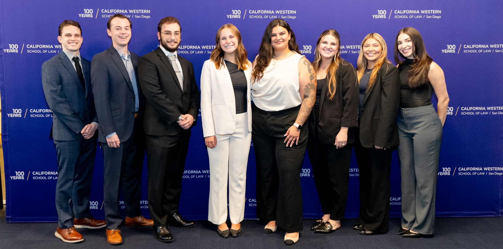 Current board members lined up shoulder to shoulder against a purple backdrop that reads "California Western School of Law San Diego"