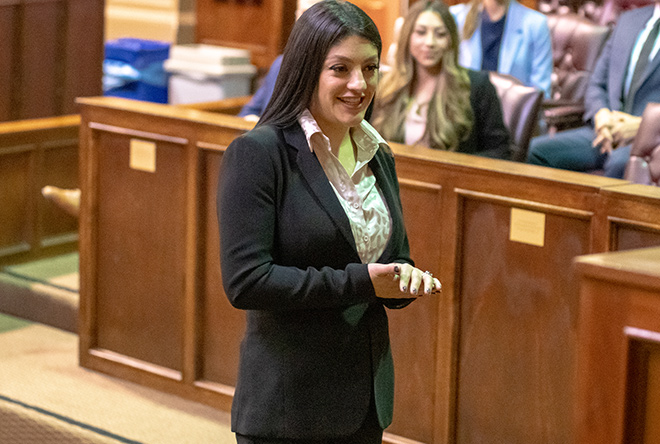 female student cross examining in front of a jury