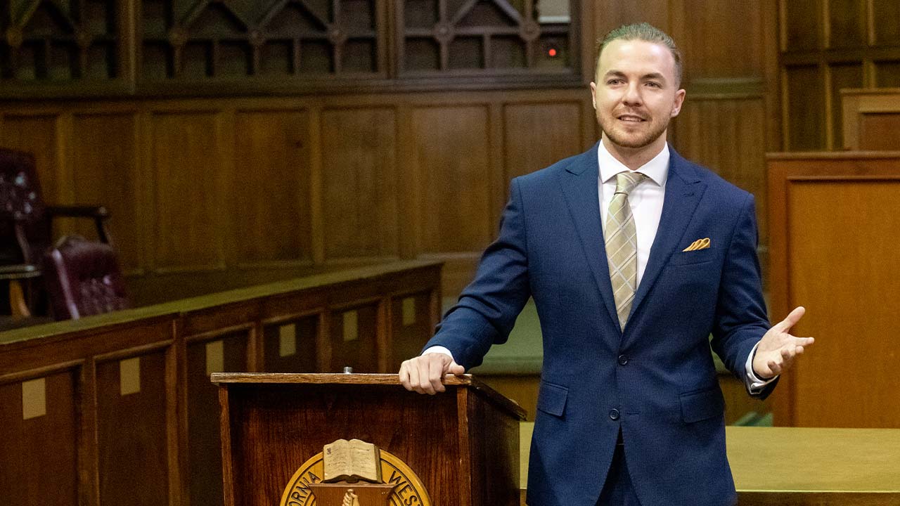 Student inside the moot courtroom talking at the podium