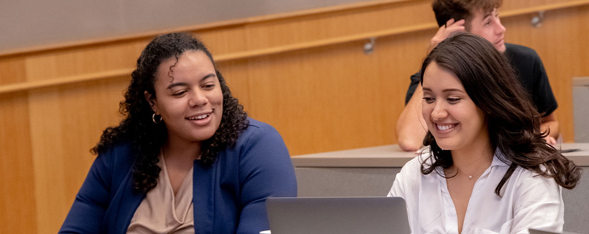 Two students talking about discussion in a classroom