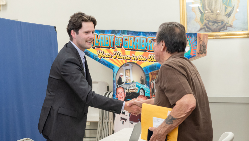 A student CLP member shakes hands with a client.