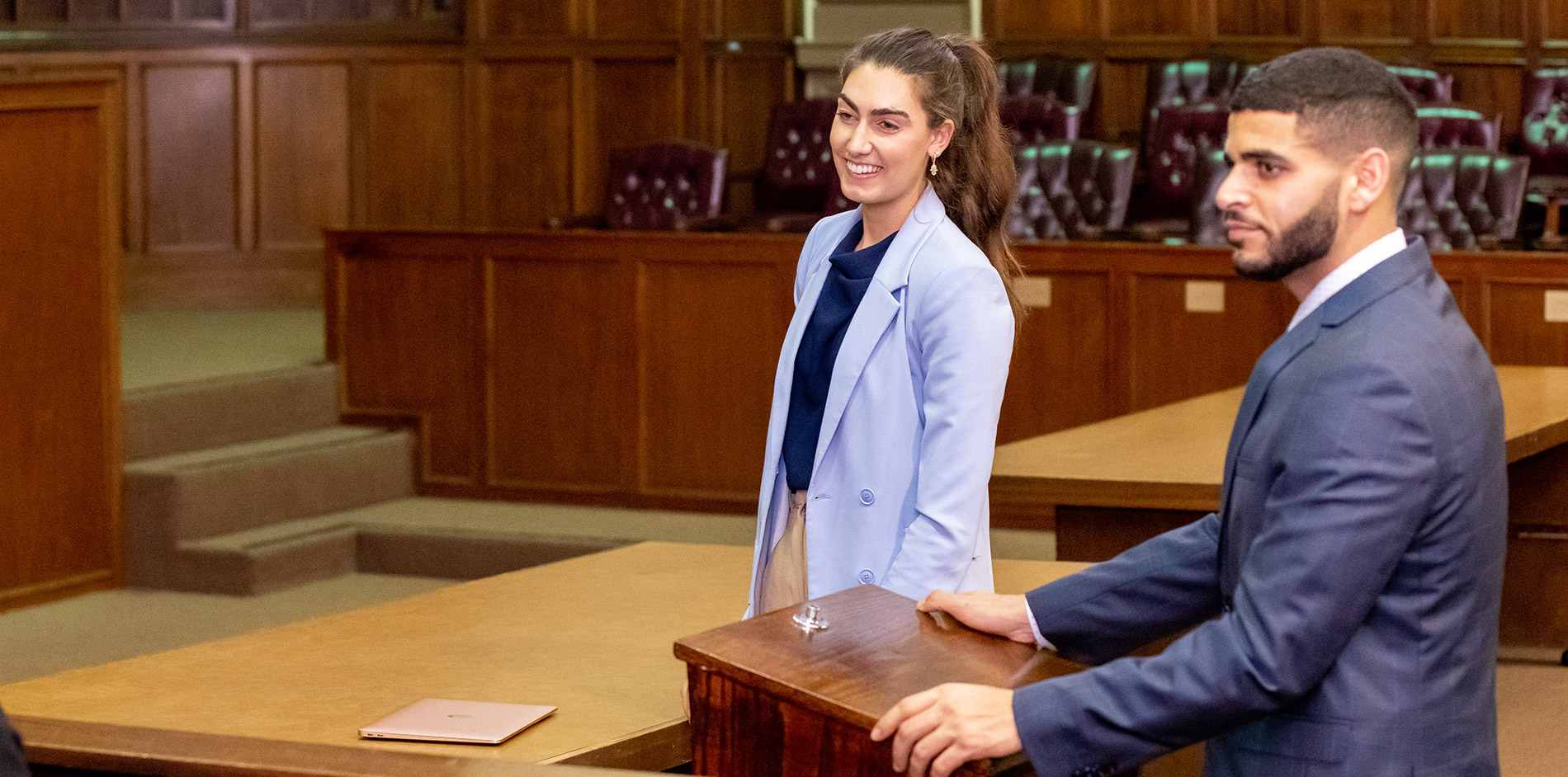 Two students discussion a case in the Moot Courtroom