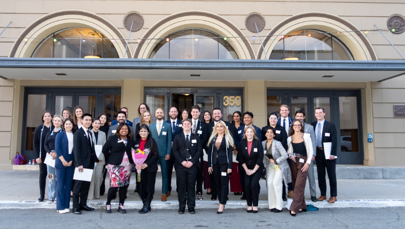 Inductees pose with Assistant Director of Pro Bono & Public Service Bhashini Weerasinghe and Keynote Speaker Anne S. Baustista '97