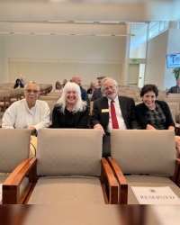 Sean Scott, Susan Bisom-Rapp, Ken Klein, and Dana Sisitsky sit together in tan chairs .