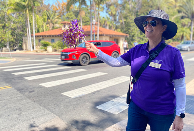 California Western employee greeting guests at commencement