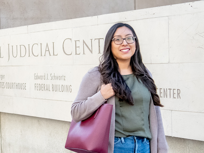 Female student in front of judicial center sign