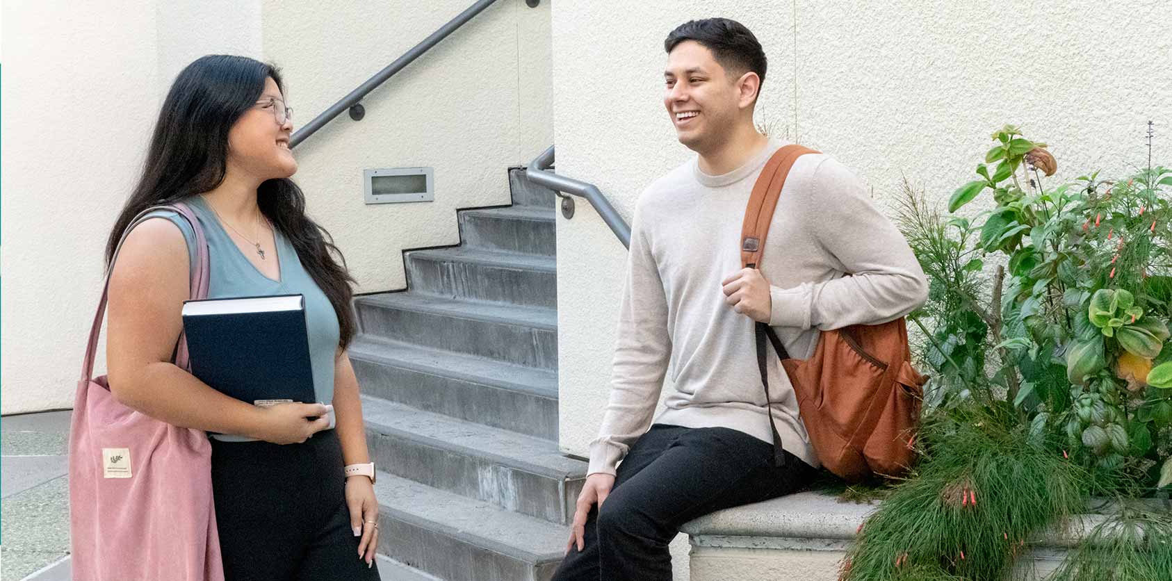 Two students talking in the courtyard