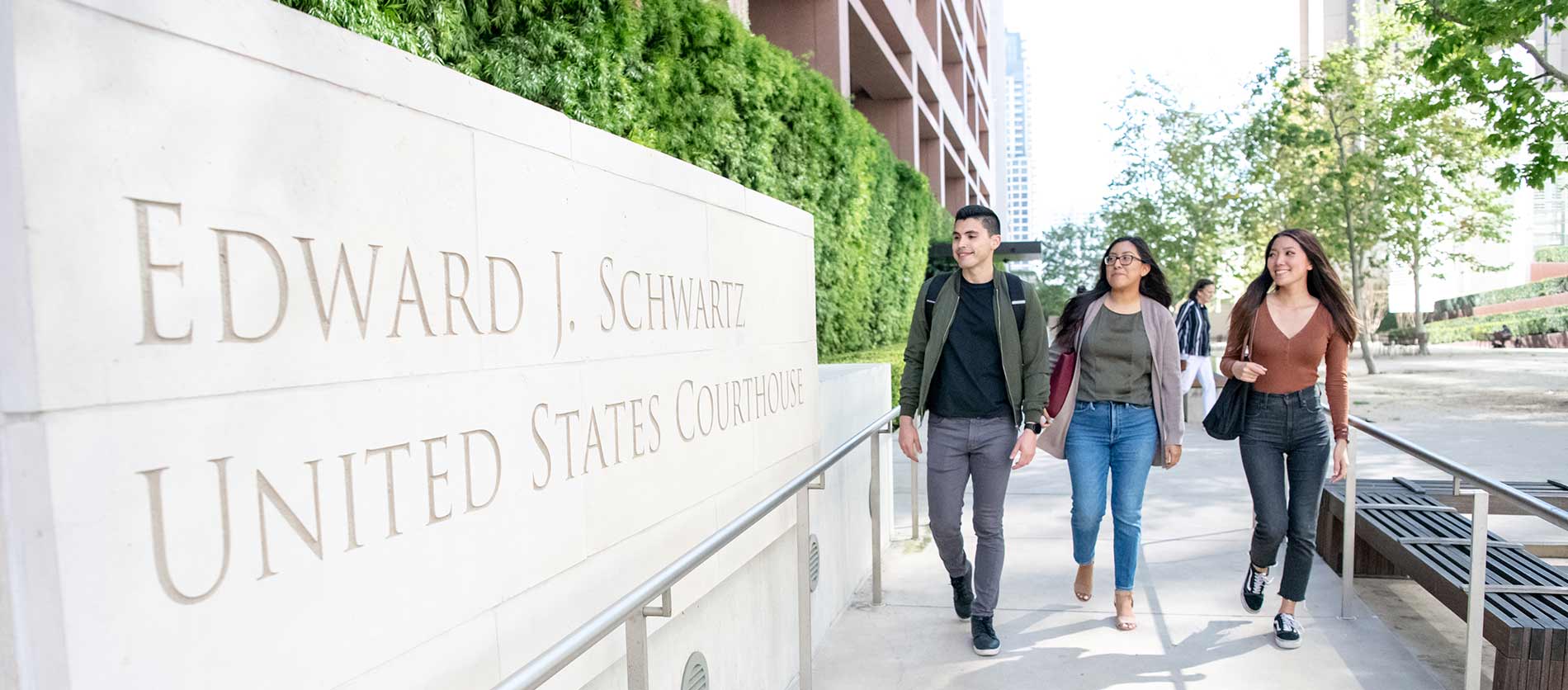 Three students walking in front of US Courthouse sign
