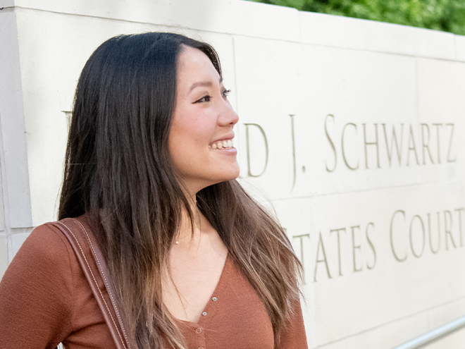 Student outside federal courthouse building