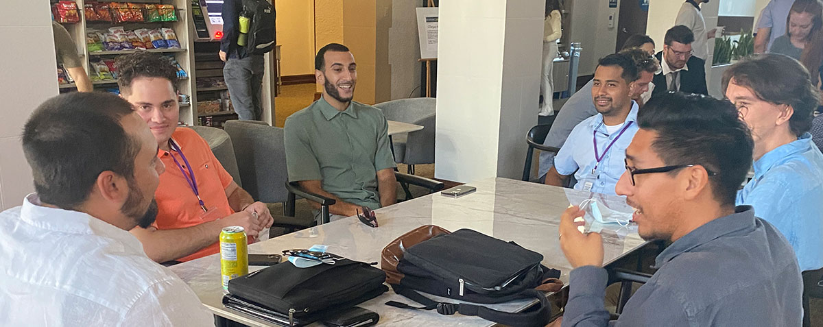 Male students laughing and talking in student lounge