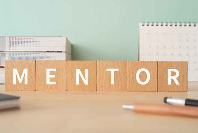 blocks spelling mentor on a desk with pens and paper