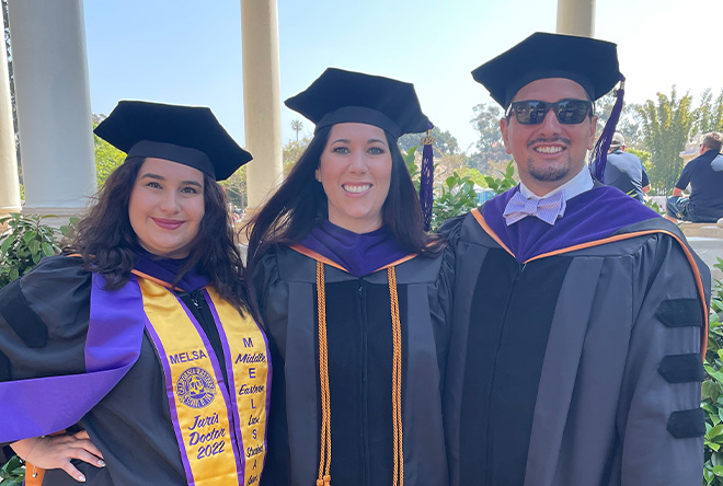 three students at commencement